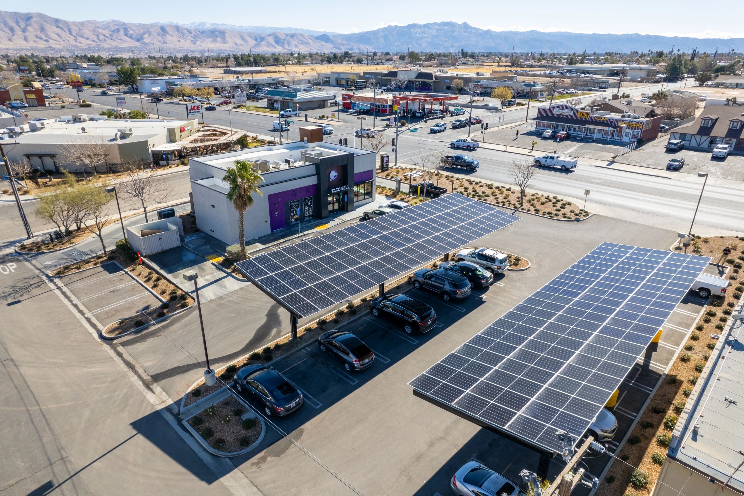 Aerial view of Taco Bell with solar canopy covering parking lot